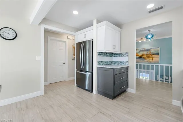 a kitchen with stainless steel appliances granite countertop a refrigerator and a stove