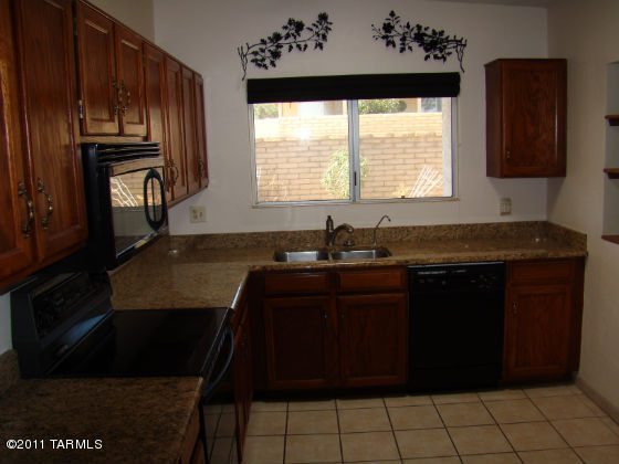 1443 North Rio-Aros Green Valley, AZ 85614 - Photo 5 of 19 a kitchen with a sink a window and cabinets