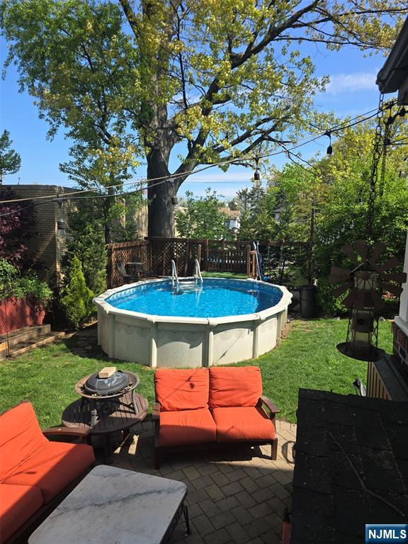 585 Monroe Place Ridgefield, NJ 07657 - Photo 28 of 28 a backyard of a house with outdoor seating