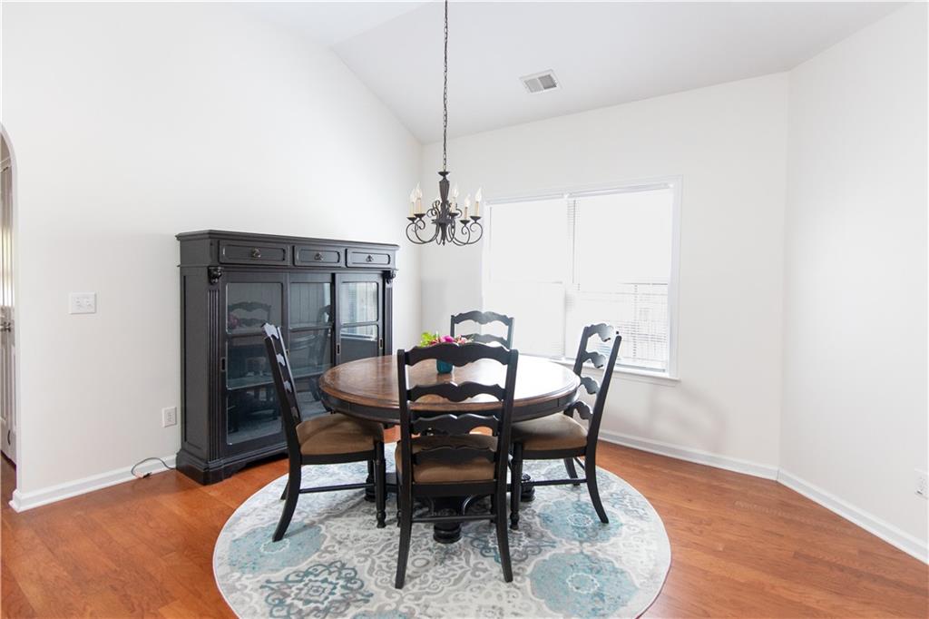 213 Oakleaf Drive Acworth, GA 30102 - Photo 11 of 24 a view of a dining room with furniture and wooden floor