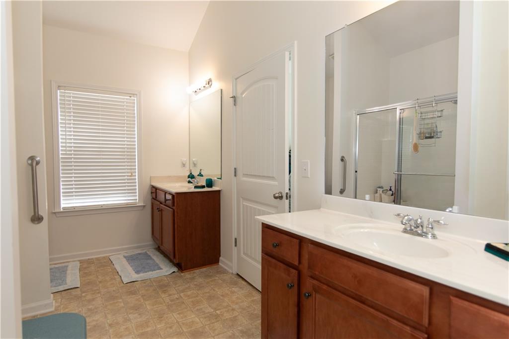 213 Oakleaf Drive Acworth, GA 30102 - Photo 16 of 24 a bathroom with a double vanity sink and a mirror