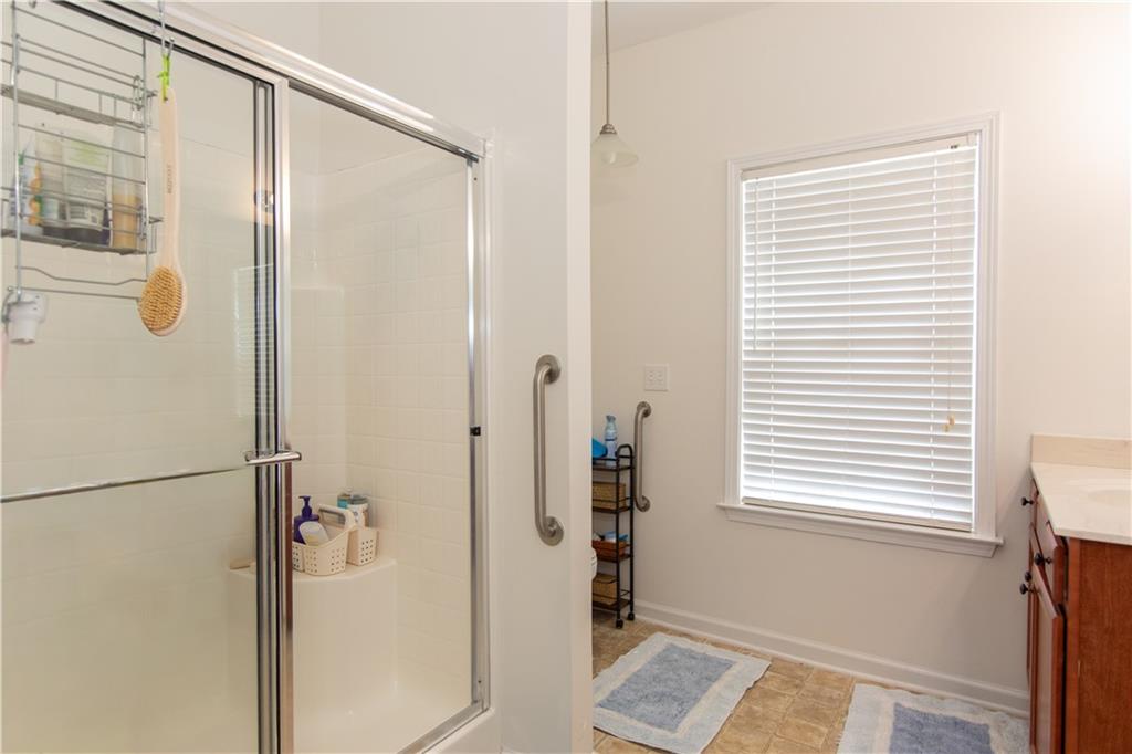 213 Oakleaf Drive Acworth, GA 30102 - Photo 17 of 24 a bathroom with a shower and a window