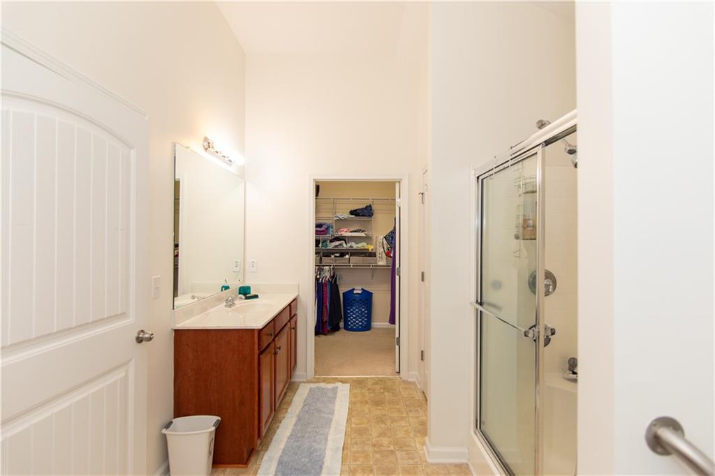213 Oakleaf Drive Acworth, GA 30102 - Photo 18 of 24 a en suite bathroom with a double vanity sink a mirror and a shower