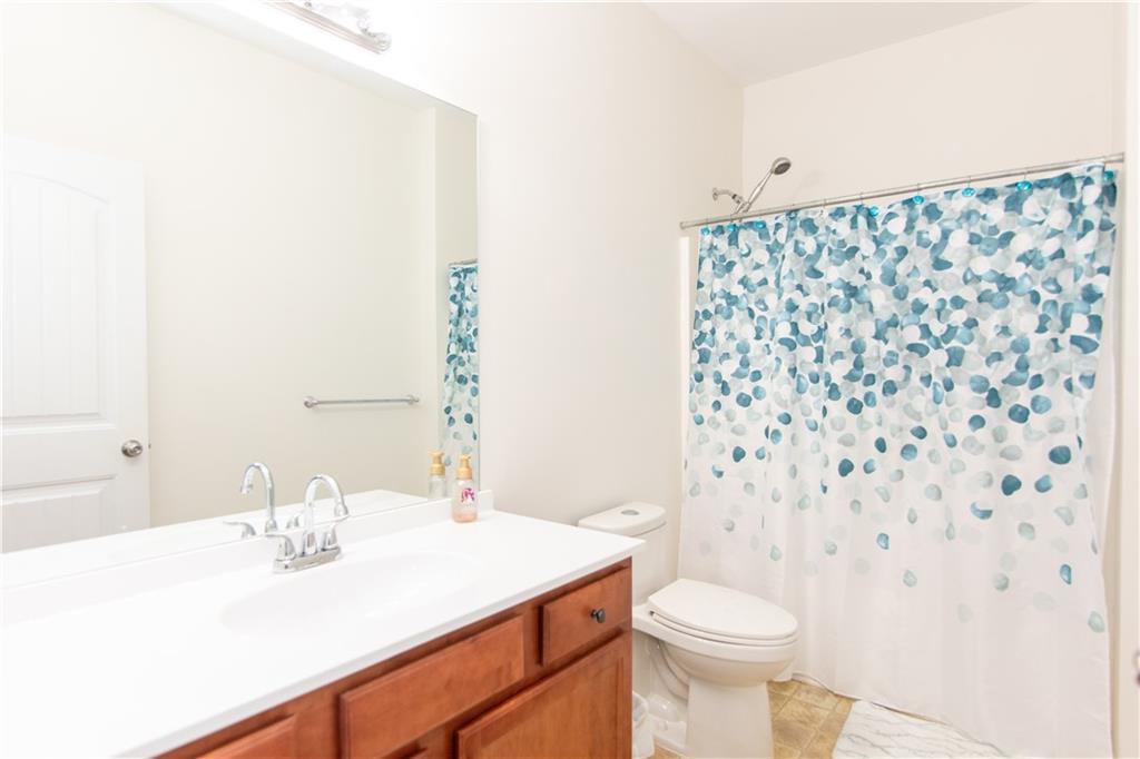 213 Oakleaf Drive Acworth, GA 30102 - Photo 22 of 24 a bathroom with a sink toilet and shower