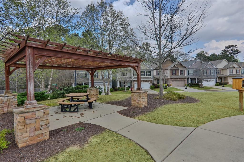 213 Oakleaf Drive Acworth, GA 30102 - Photo 23 of 24 a patio with a table and chairs under an umbrella