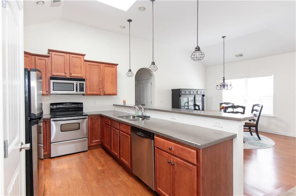 213 Oakleaf Drive Acworth, GA 30102 - Photo 8 of 24 a kitchen with stainless steel appliances granite countertop a sink a stove and a refrigerator