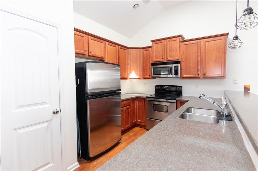 213 Oakleaf Drive Acworth, GA 30102 - Photo 9 of 24 a kitchen with granite countertop a refrigerator stove and microwave