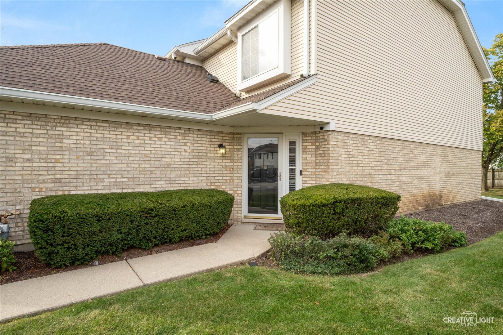 378 Lakeview Circle Bolingbrook, IL 60440 - Photo 2 of 19 a front view of a house with a garden