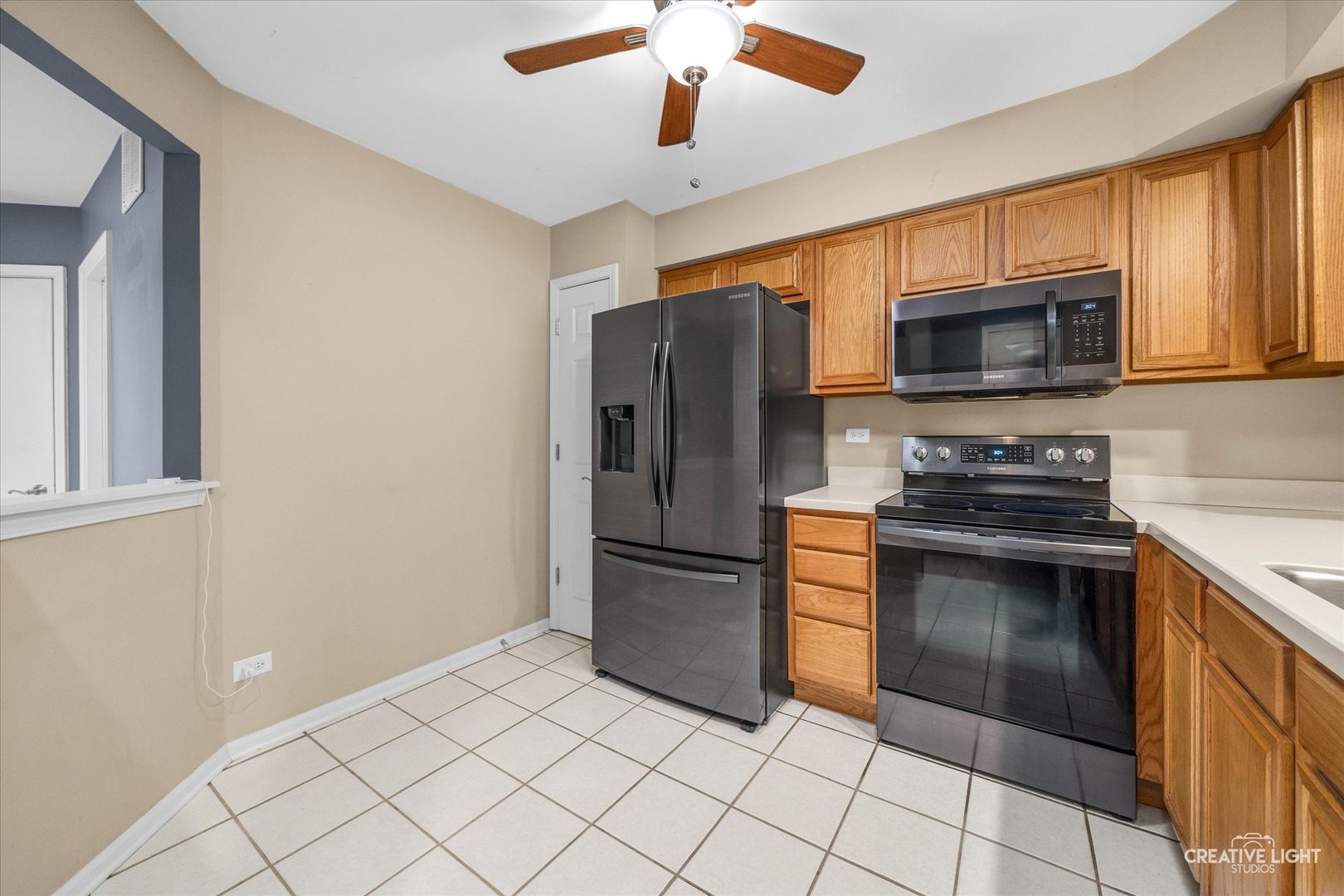 378 Lakeview Circle Bolingbrook, IL 60440 - Photo 6 of 19 a kitchen with granite countertop a refrigerator and a stove top oven