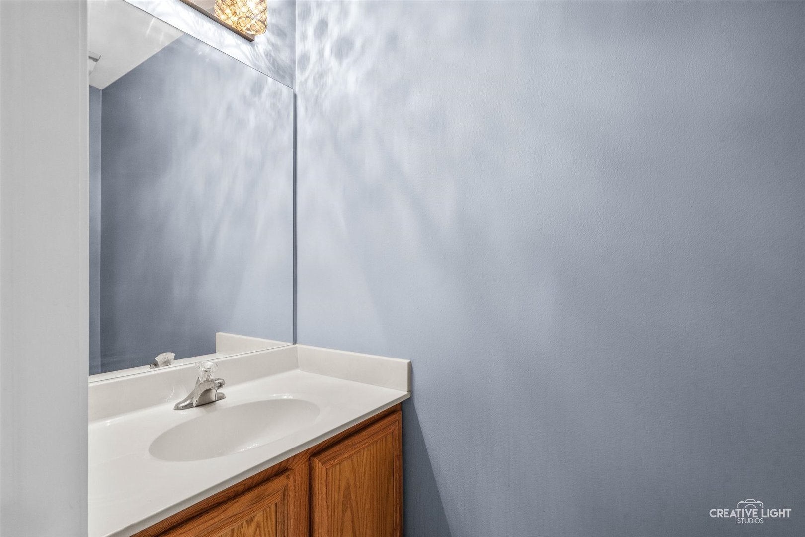 378 Lakeview Circle Bolingbrook, IL 60440 - Photo 9 of 19 a bathroom with a sink and a mirror