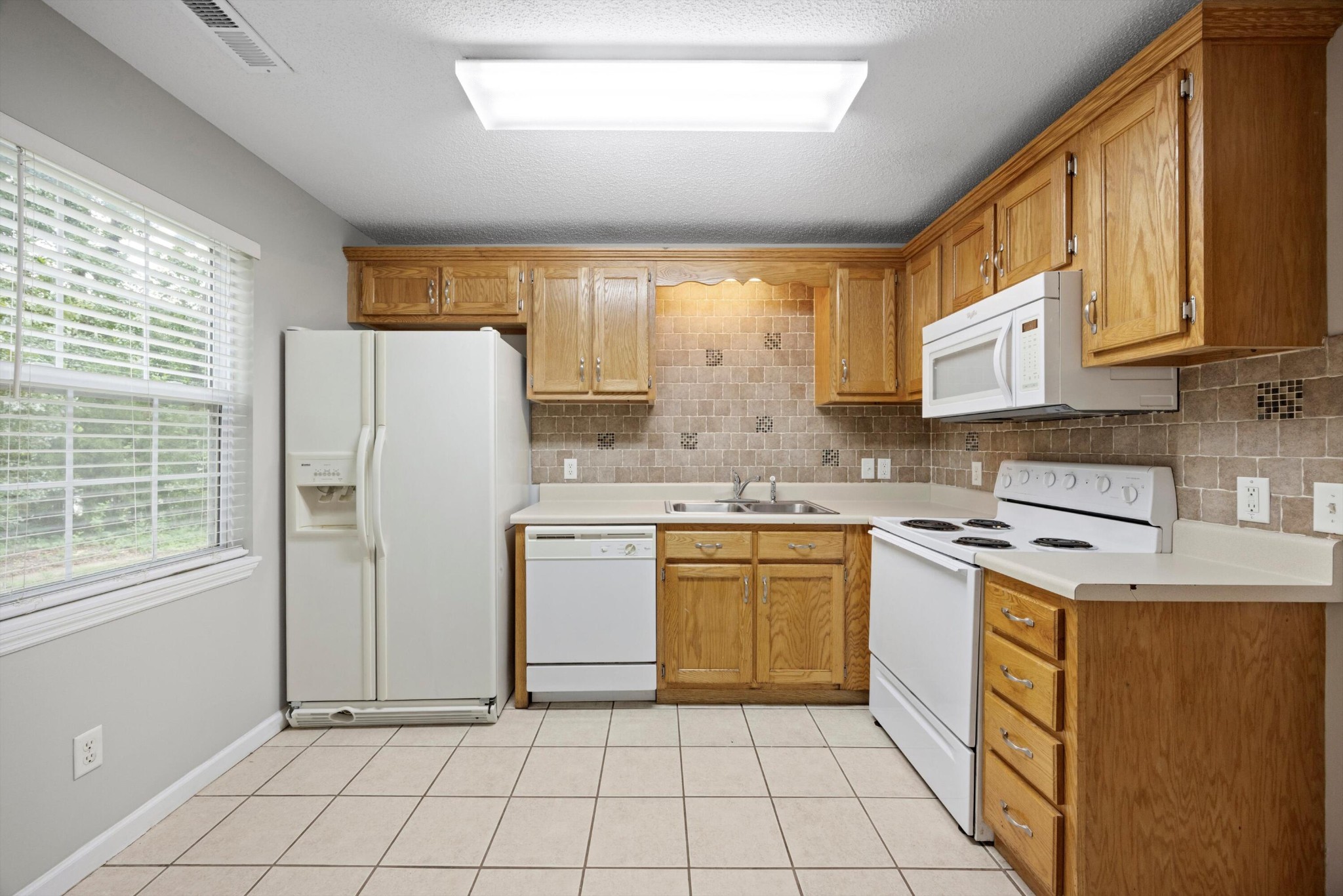 155 Priscilla Drive Ringgold, GA 30736 - Photo 7 of 19 a kitchen with stainless steel appliances granite countertop a stove a sink and a refrigerator