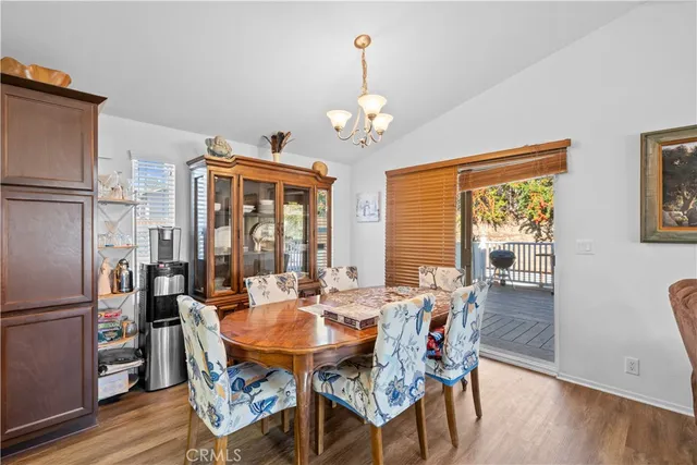 a view of a dining room with furniture wooden floor and chandelier