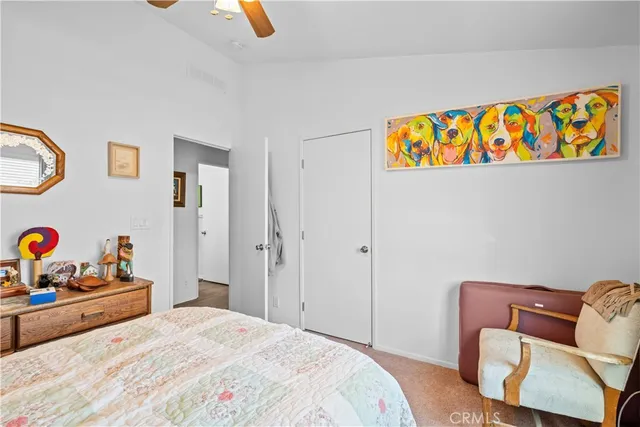 a bedroom with a bed window and a chandelier