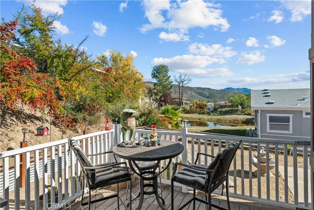 a view of a chairs and table on the wooden deck