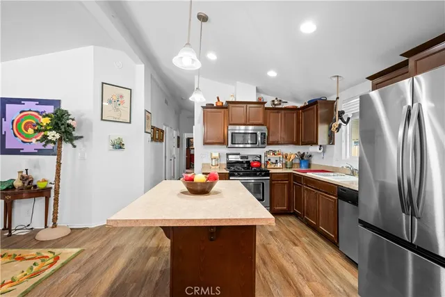 a kitchen with stainless steel appliances a refrigerator sink stove microwave and cabinets