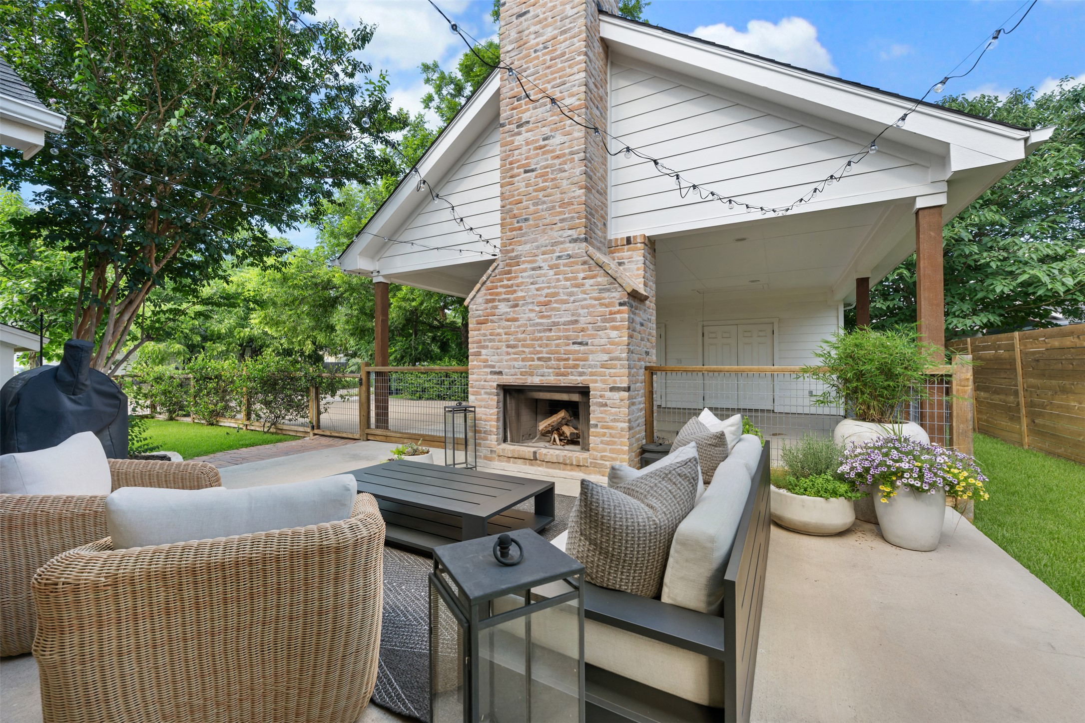 1301 West Street Georgetown, TX 78626 - Photo 39 of 40 An inviting outdoor living space features a charming brick fireplace and ample seating for alfresco gatherings.