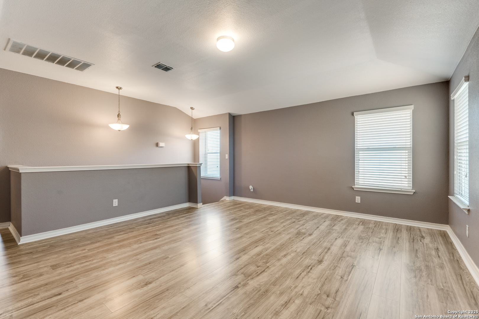 7522 Rigel Chase San Antonio, TX 78252 - Photo 11 of 19 an empty room with wooden floor and windows