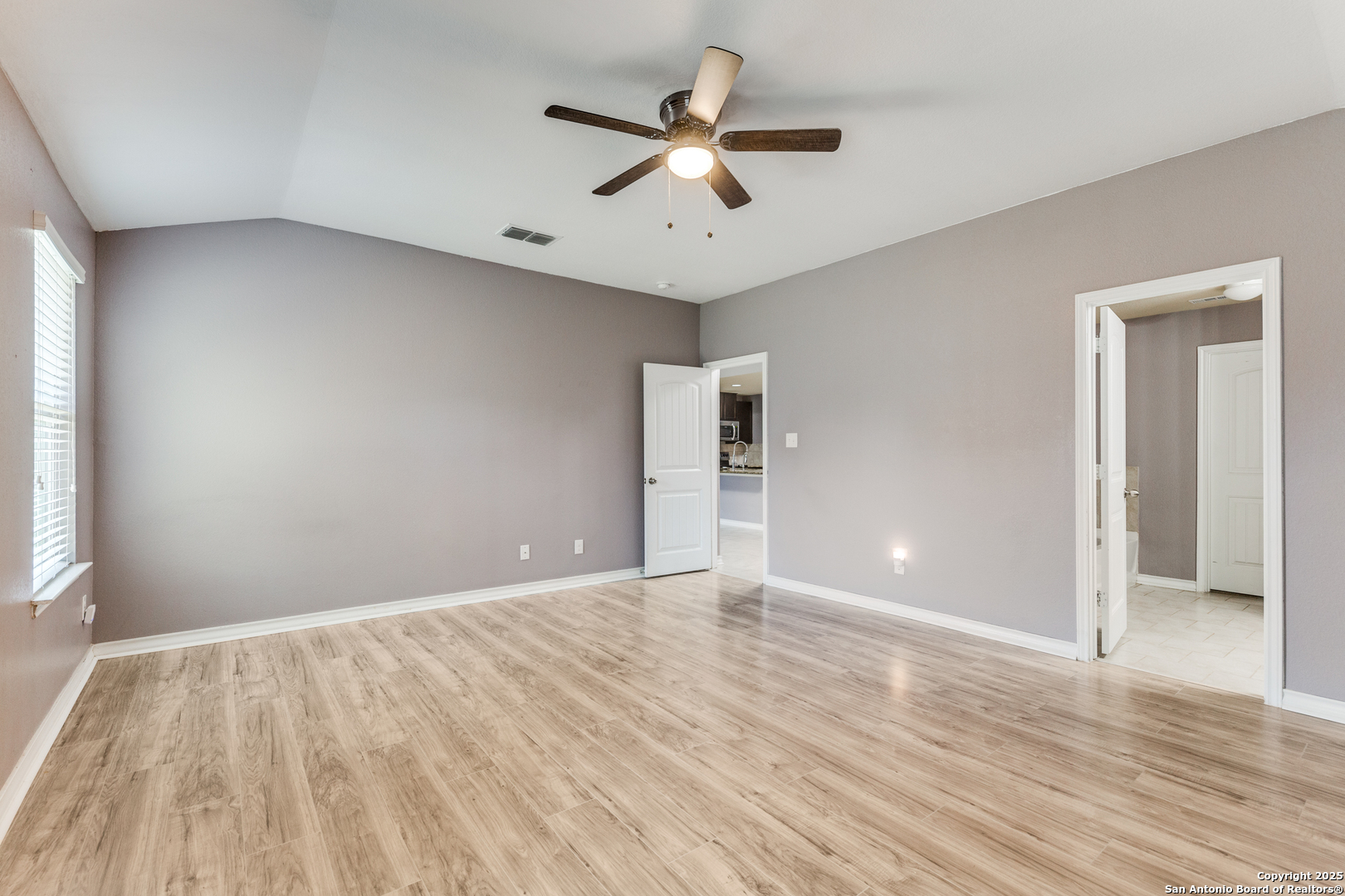 7522 Rigel Chase San Antonio, TX 78252 - Photo 7 of 19 wooden floor in an empty room with a window