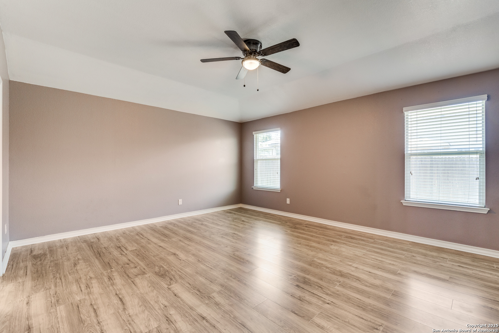 7522 Rigel Chase San Antonio, TX 78252 - Photo 8 of 19 an empty room with wooden floor and windows