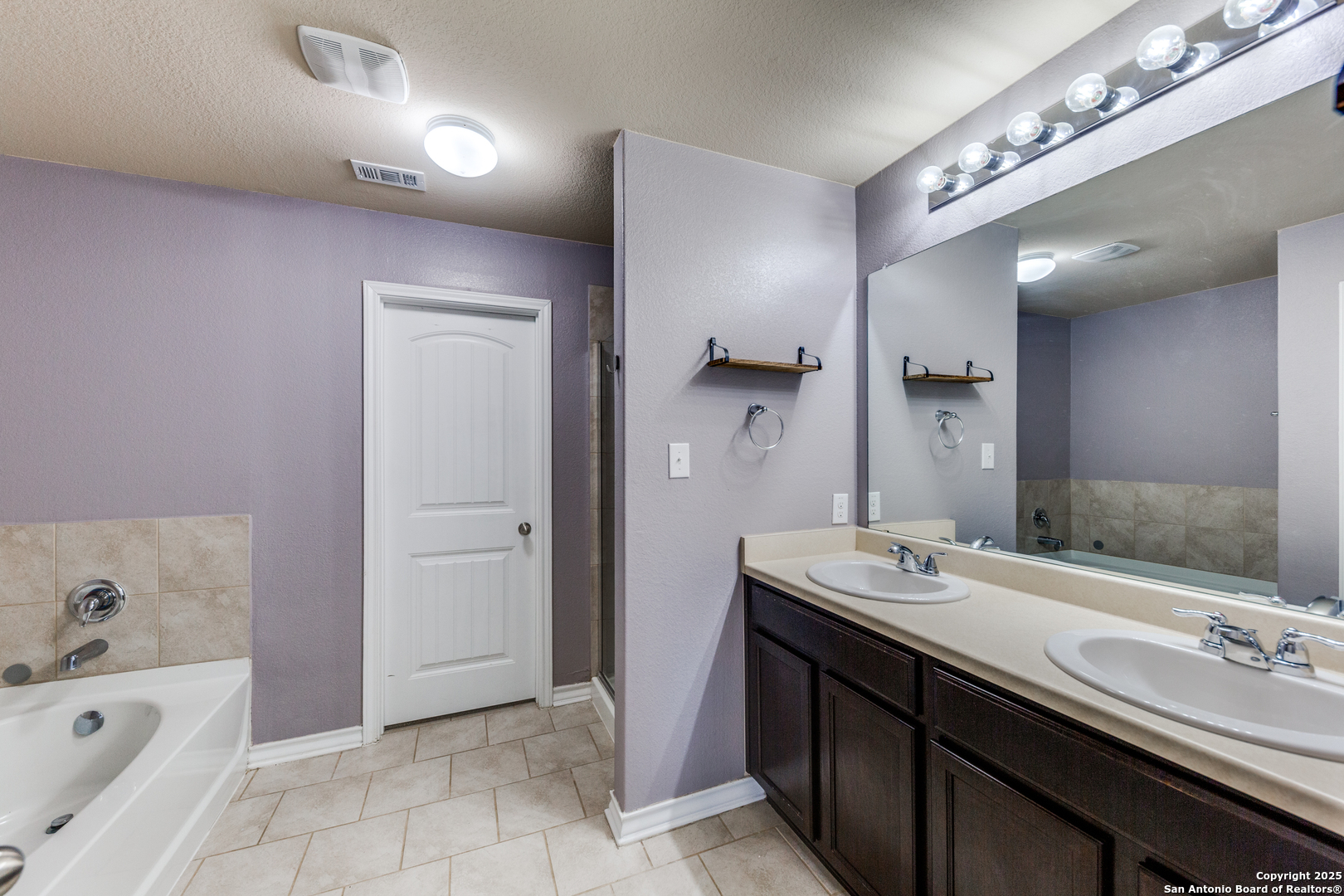 7522 Rigel Chase San Antonio, TX 78252 - Photo 10 of 19 a bathroom with a sink double vanity and a bathtub