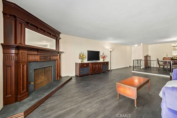 a living room with furniture a fireplace and flat screen tv