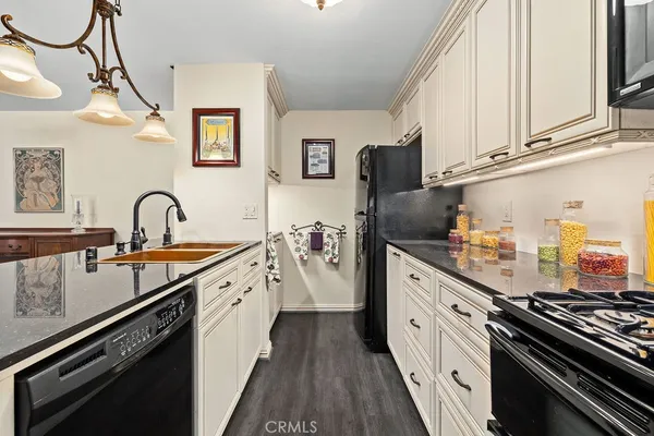 a kitchen with stainless steel appliances a sink stove and cabinets
