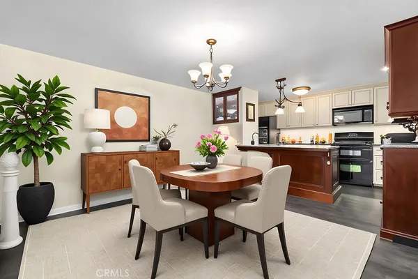a dining room with furniture potted plants and wooden floor