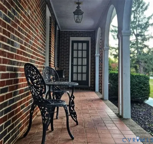 a view of a dinning table and chairs in patio of a house