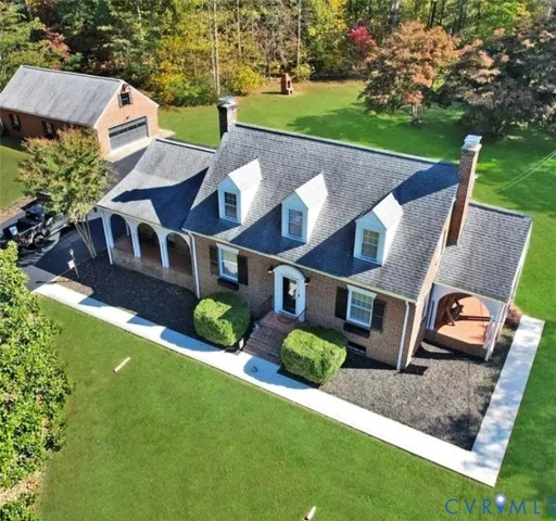 an aerial view of a house with garden space and street view