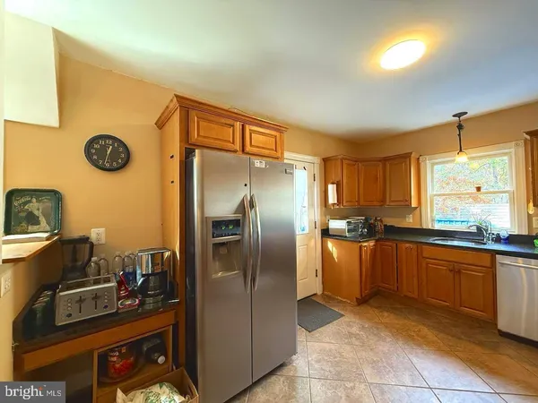 a kitchen with stainless steel appliances granite countertop a refrigerator and a stove
