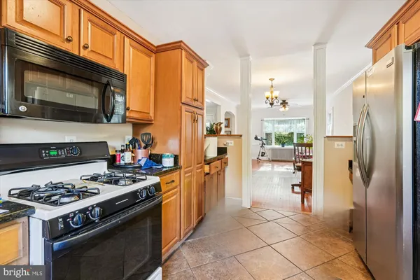 a kitchen with stainless steel appliances a stove a refrigerator and a stove