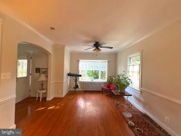 a living room with furniture or wooden floor and a chandelier