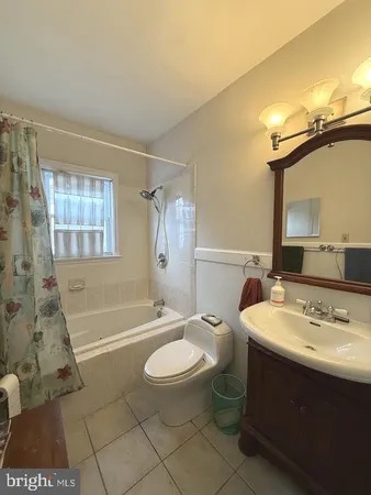 a bathroom with a sink a toilet a tub and shower