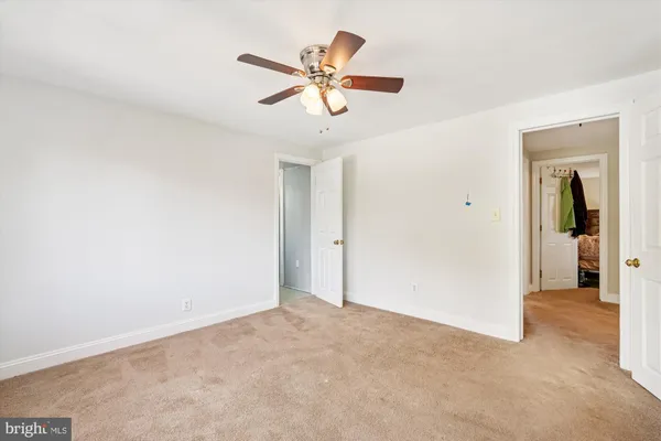 a utility room with dryer washer and stair