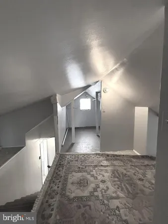 a utility room with dryer washer and a view of living room