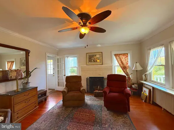 a living room with furniture ceiling fan and a window