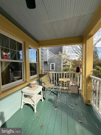 a view of a house with a backyard and a tree