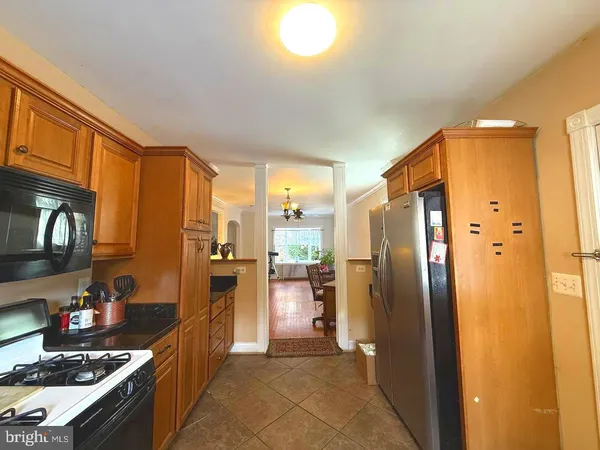 a kitchen with stainless steel appliances granite countertop a refrigerator and a stove