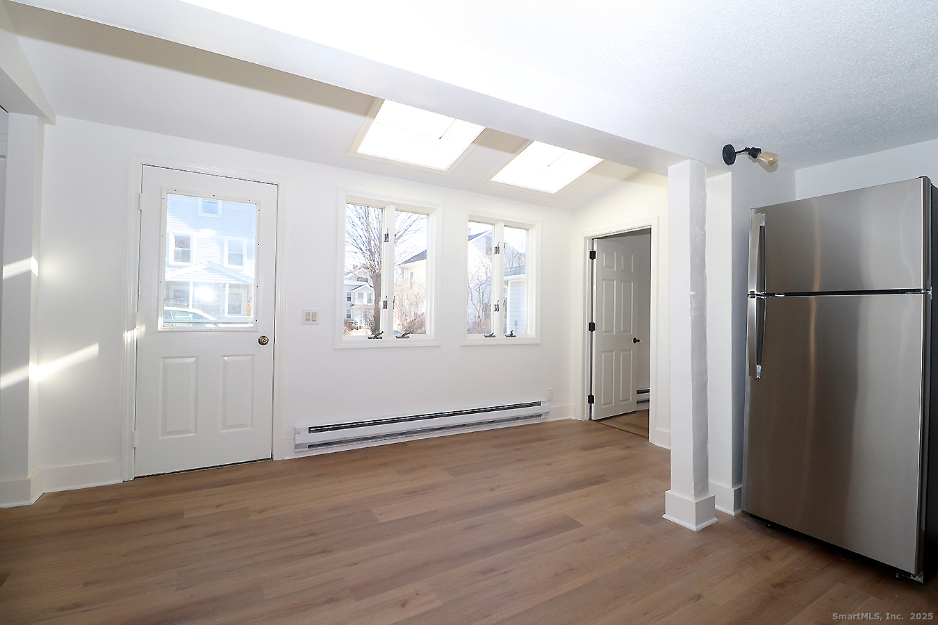 9 John Street Winchester, CT 06098 - Photo 11 of 23 an empty room with wooden floor and a window