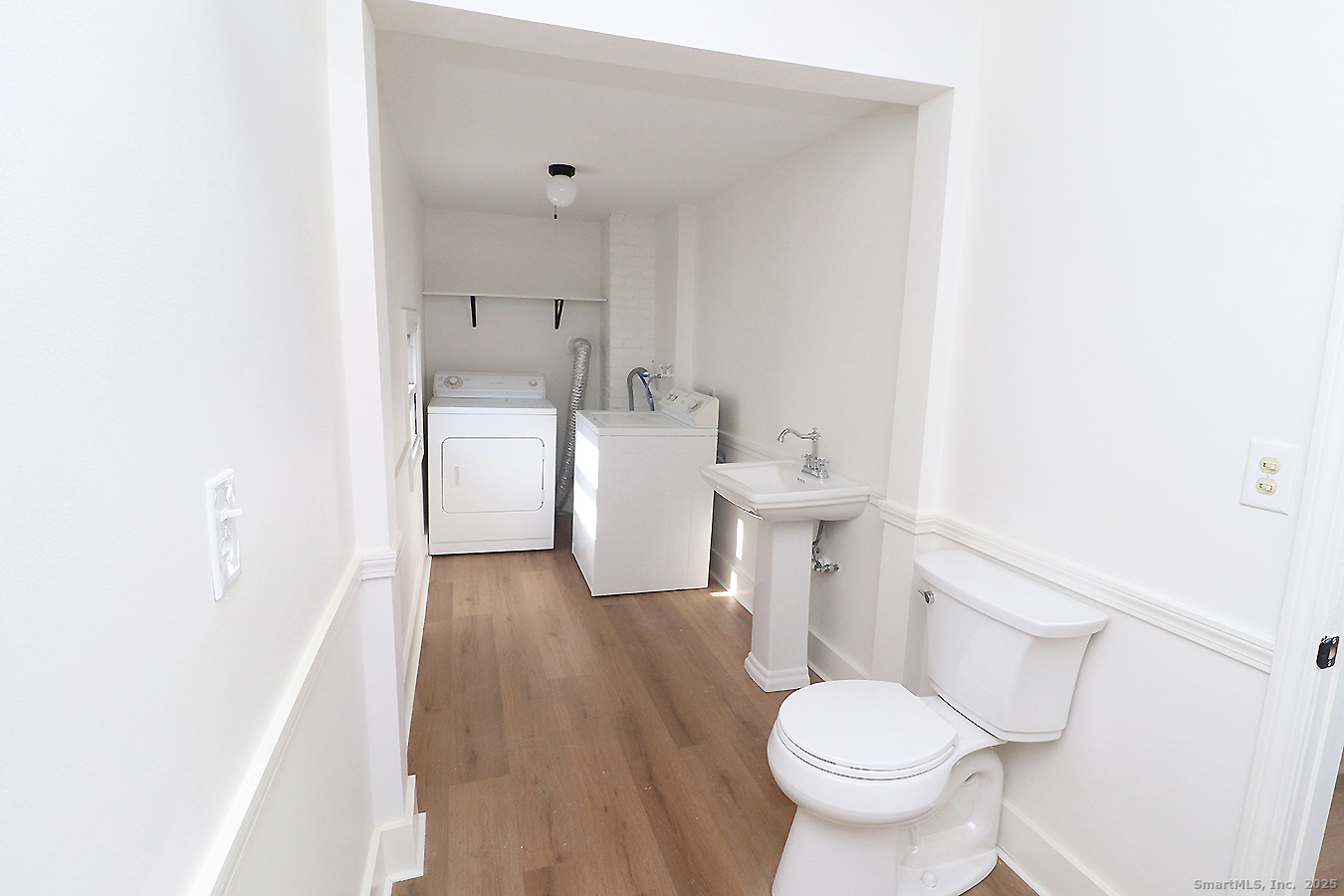 9 John Street Winchester, CT 06098 - Photo 13 of 23 a white toilet sitting next to a bathroom sink