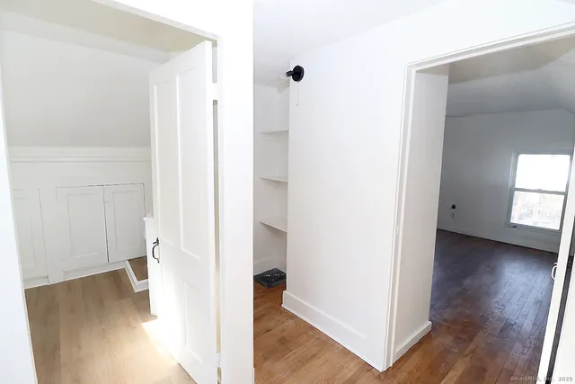 a view of hallway with wooden floor
