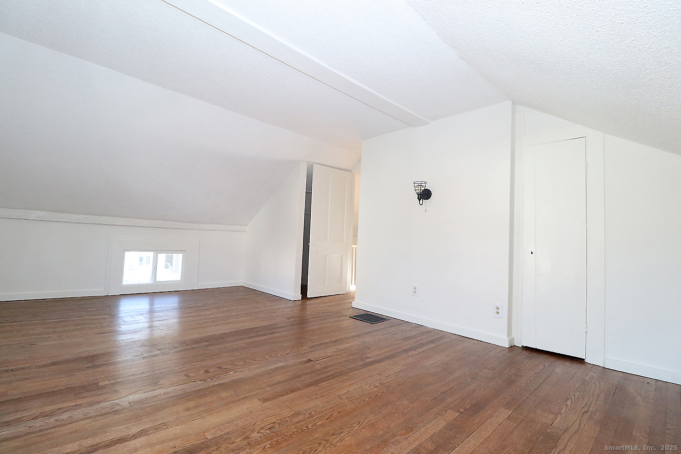 9 John Street Winchester, CT 06098 - Photo 18 of 23 an empty room with wooden floor and windows