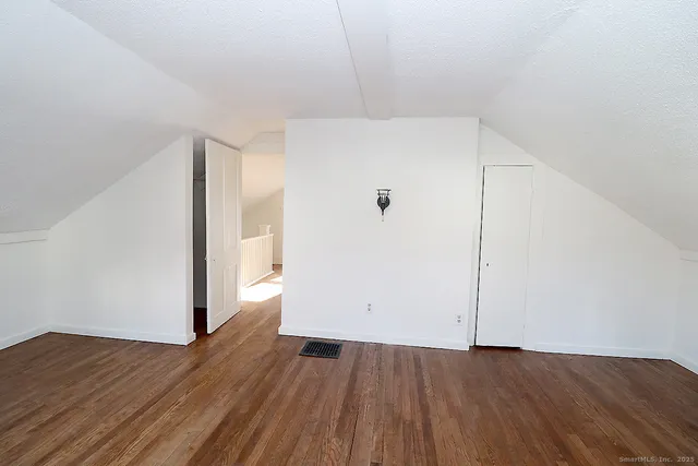 an empty room with wooden floor