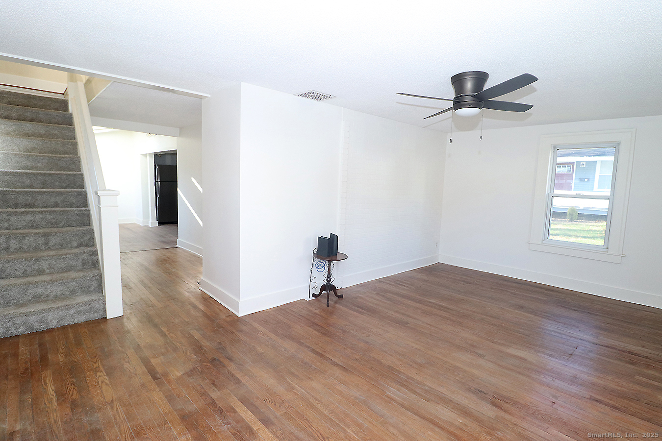 9 John Street Winchester, CT 06098 - Photo 3 of 23 a view of a room with wooden floor and ceiling fan