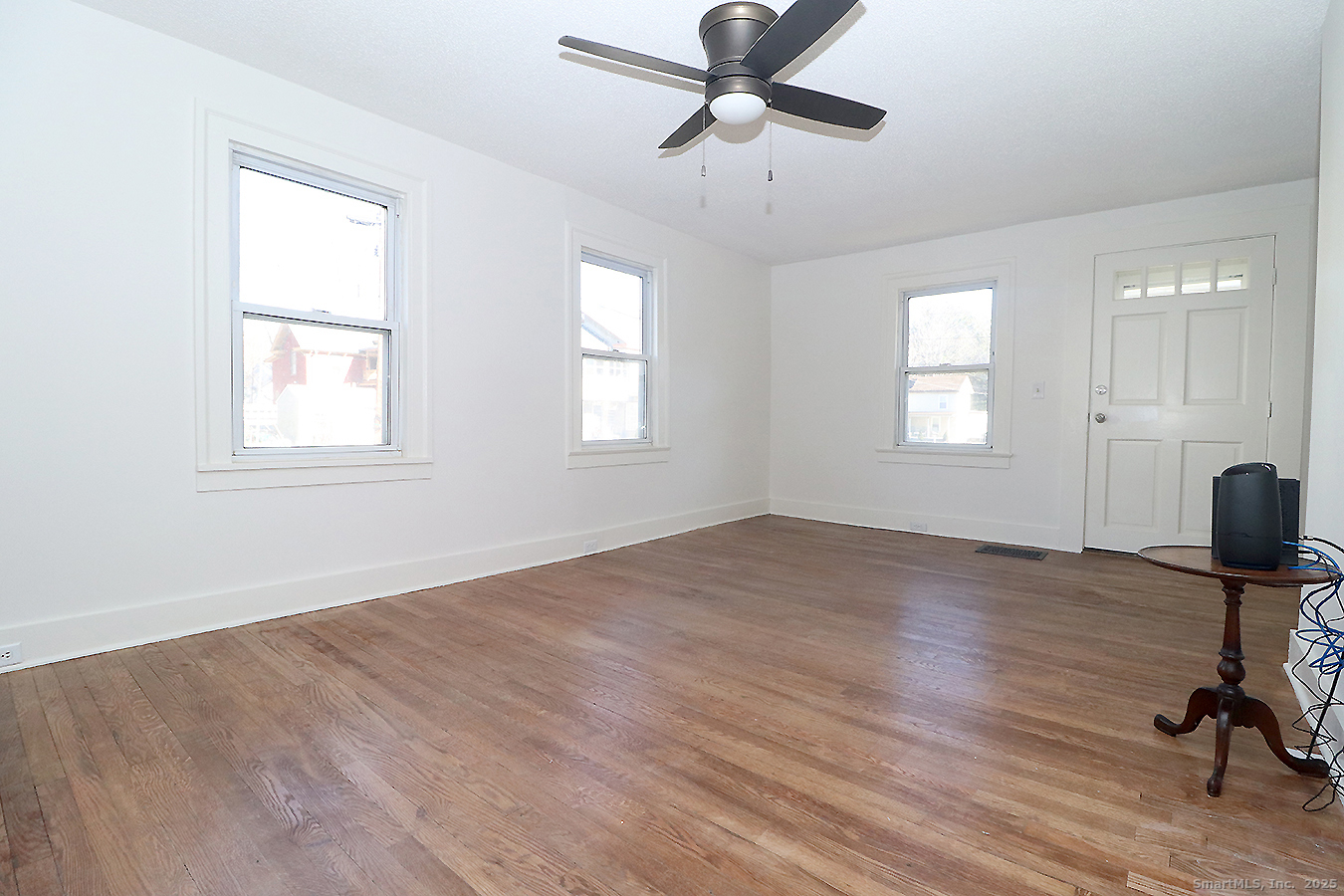 9 John Street Winchester, CT 06098 - Photo 4 of 23 a view of empty room with wooden floor and fan