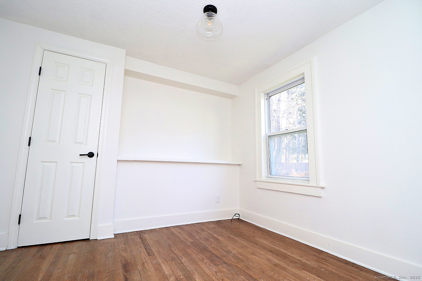 9 John Street Winchester, CT 06098 - Photo 7 of 23 an empty room with wooden floor and windows