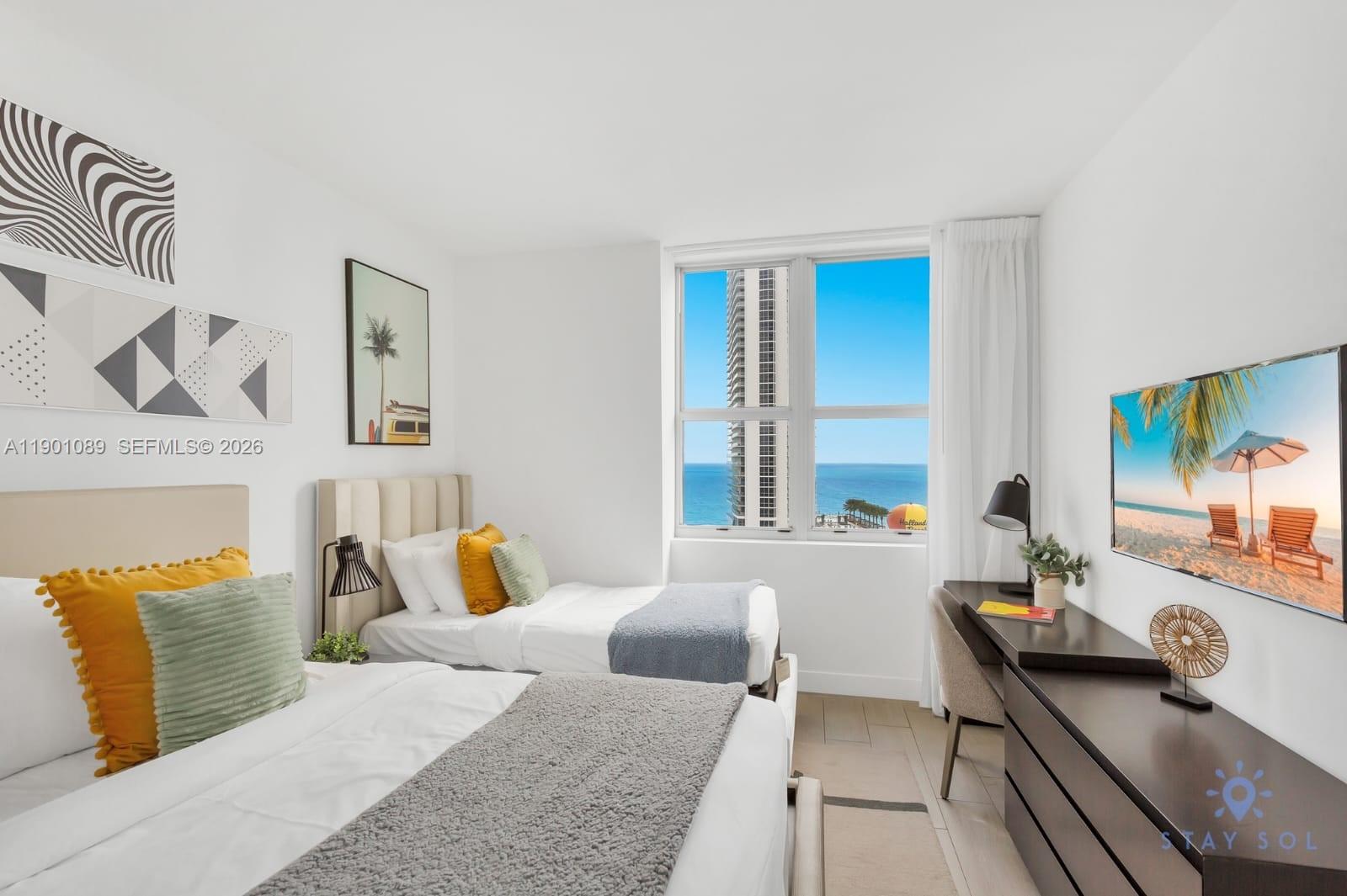 4010 South Ocean Drive, Unit R1709 Hollywood, FL 33019 - Photo 12 of 16 a bedroom with a bed and window