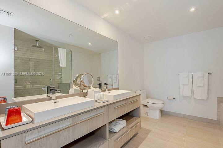 4010 South Ocean Drive, Unit R1709 Hollywood, FL 33019 - Photo 13 of 16 a bathroom with a double vanity sink mirror and toilet