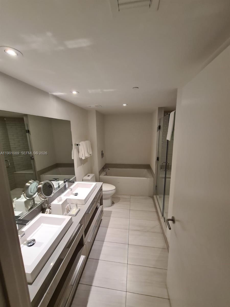 4010 South Ocean Drive, Unit R1709 Hollywood, FL 33019 - Photo 14 of 16 a bathroom with a double vanity sink and a mirror