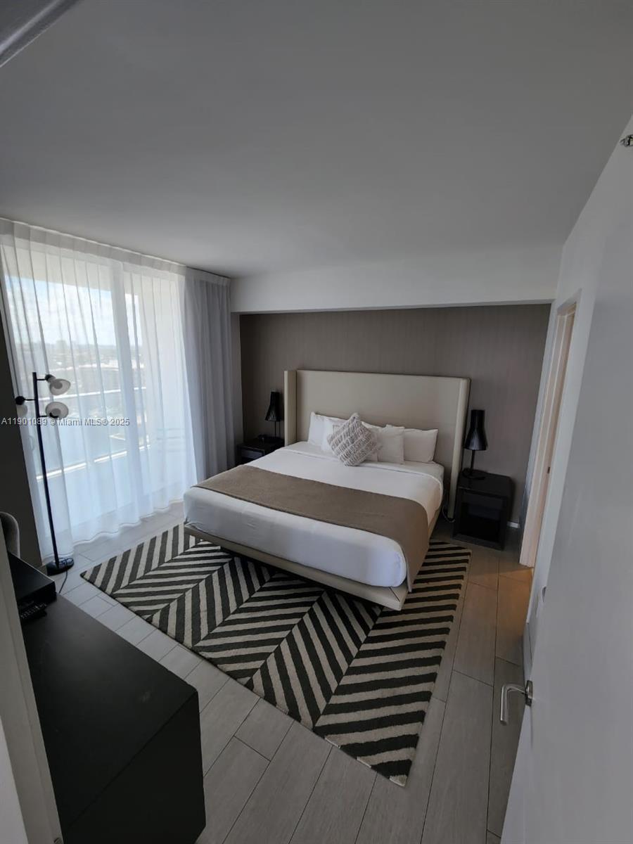 4010 South Ocean Drive, Unit R1709 Hollywood, FL 33019 - Photo 9 of 16 a bedroom with a bed and wooden floor